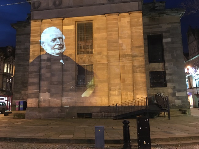 Robert Young projected on the wall of St Giles' Church, Elgin, as part of the Christmas lights 2017